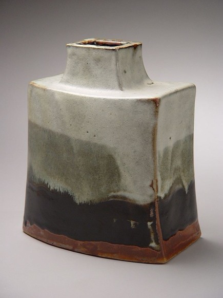 Curved and flattened jar with creamy white, dark grey and black bleeding glazes, 1960