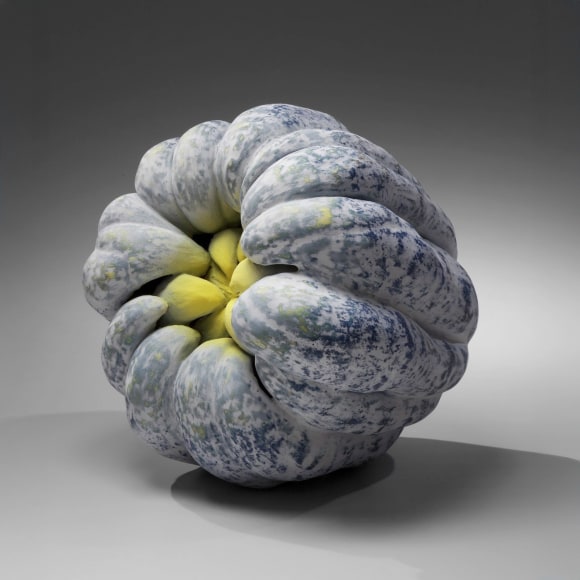 Biomorphic sculpture in the form of a hand-of-the-Buddha with layers of white and yellow matte glazes over black glaze, 2011