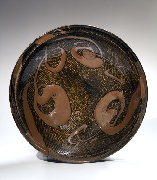 Black-glazed, rope-impressed large circular platter, ca. 1976