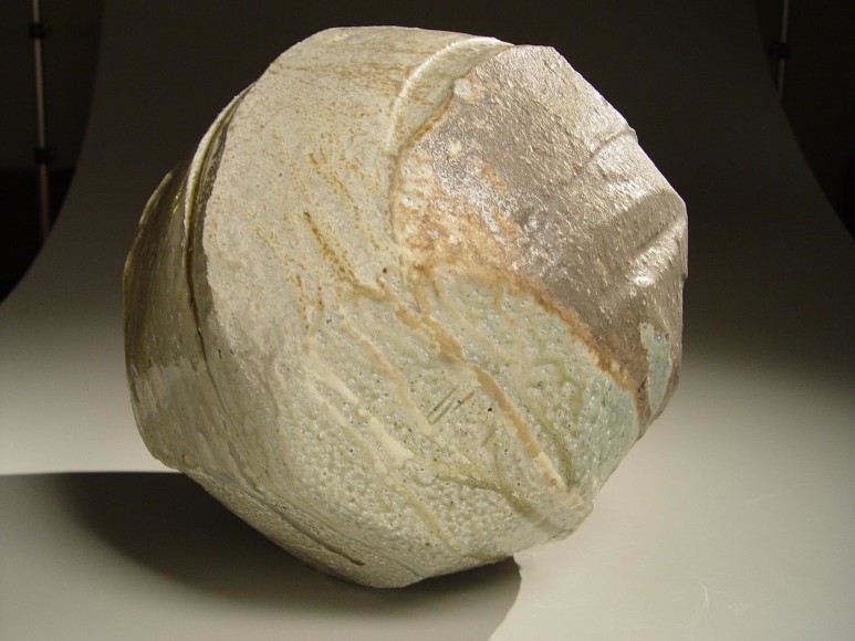 Spherical Tanba vessel with faceted diagonal banding and dripping natural ash glaze and markings from impressed shells, 2011