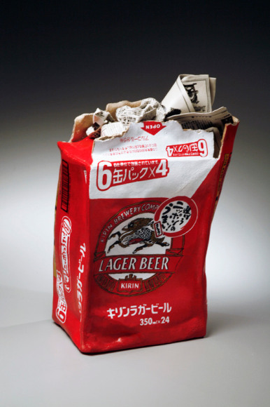 Vertical sculpture of a crushed Kirin Beer Box stuffed with newspaper, 2007