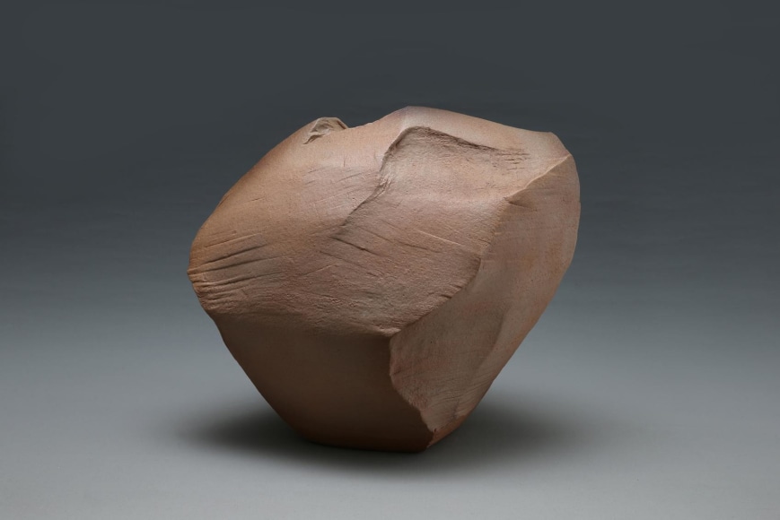 Angled rock-like, scooped-out, sculptural vessel with tapered base, striations in the body and Hagi kohiki glaze in naturalistic tones of brown and rust, 2014