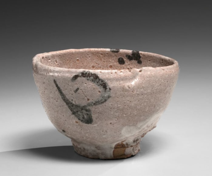 Shino round teabowl with high foot and abstract underglaze patterning in iron-oxide