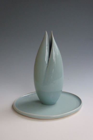 Tall incense burner in the form of a lotus bud atop a lotus leaf plate