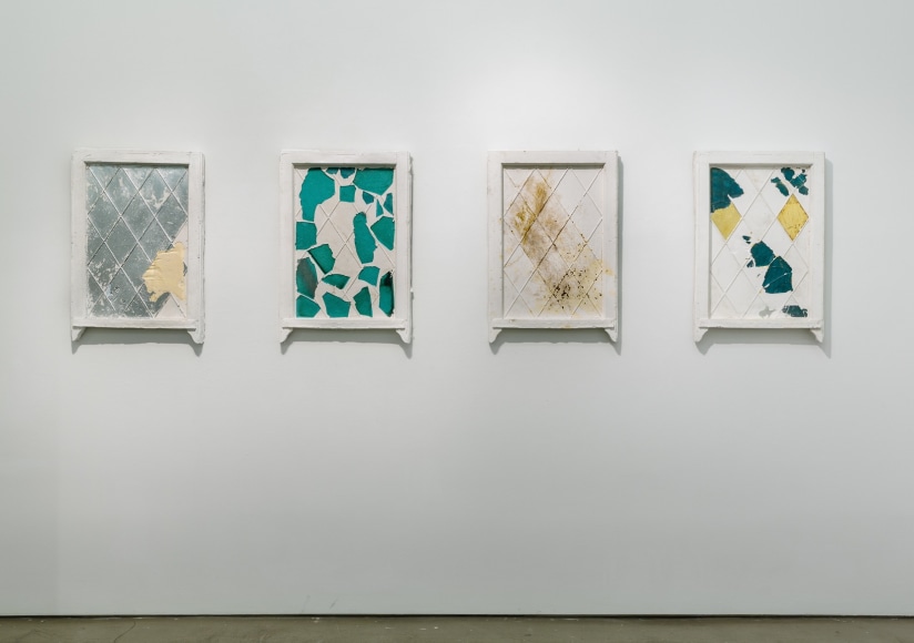 An installation of artwork by Julie Schenkelberg. Mixed media pieces line the walls