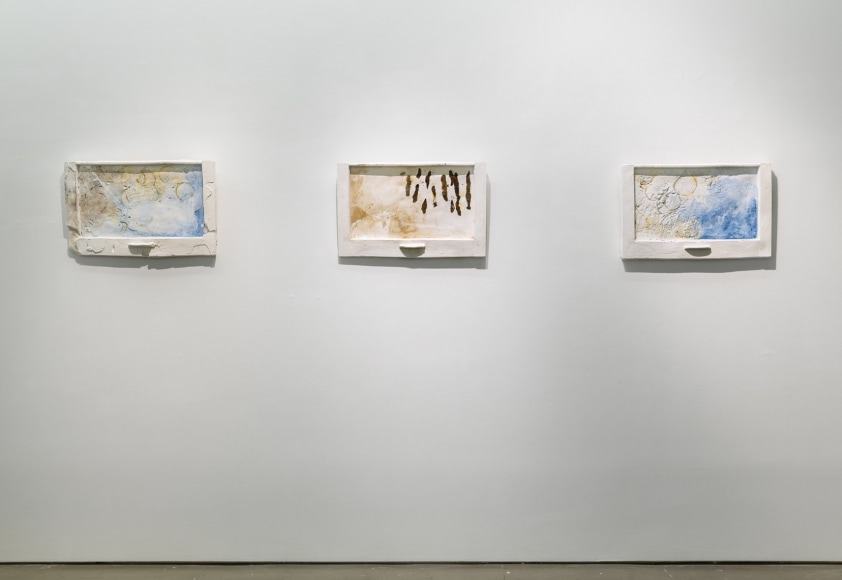 Mixed media plaster pieces line the walls