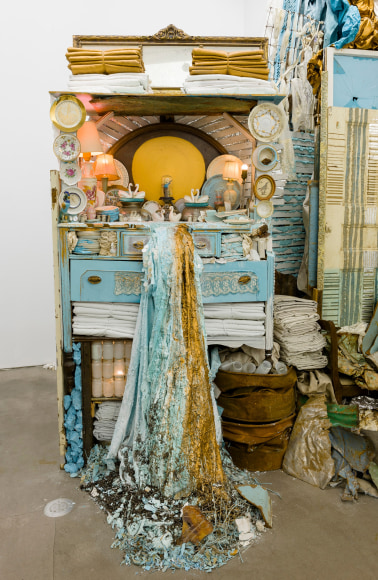 Large installation by Julie Schenkelberg including reclaimed wood and household materials