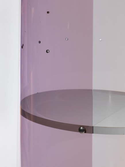 photograph of Laporte bookcase in a blank room, bookcase is rounded