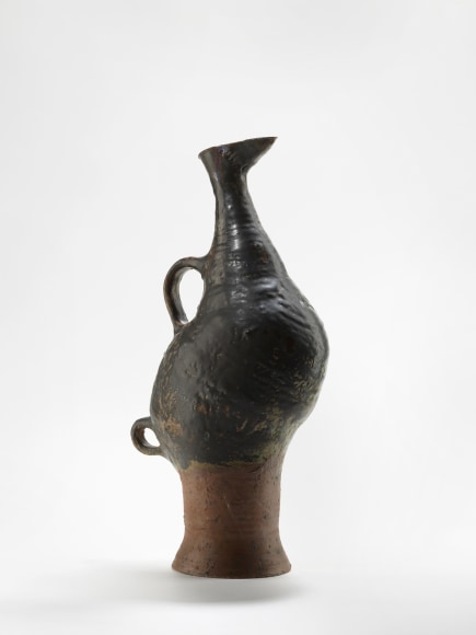 photograph of a zoomorphic bird jug in an empty room