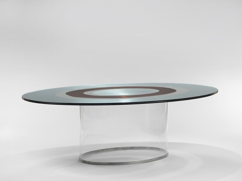 picture of a table with glass base in a gray room