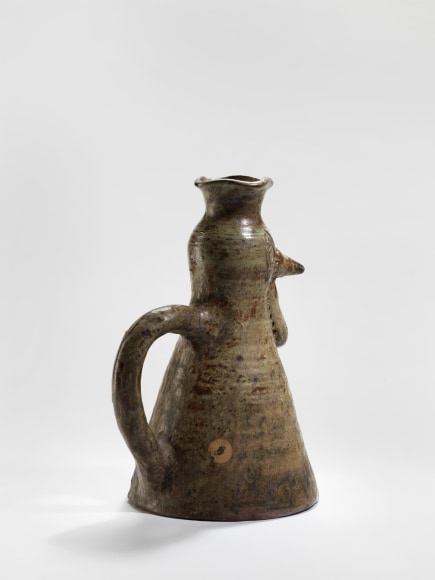 photograph of a zoomorphic hen jug in an empty room
