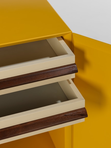 photograph of a yellow cabinet in a blank room