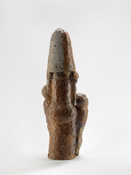 photograph of a brown sculpture in an empty room