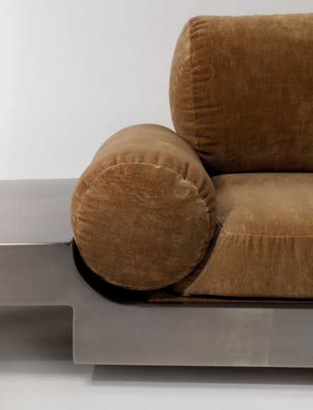 Detail close up of Maria pergay daybed with brown upholstery and steel frame.