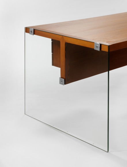 photograph of wooden desk by Motte in a blank room