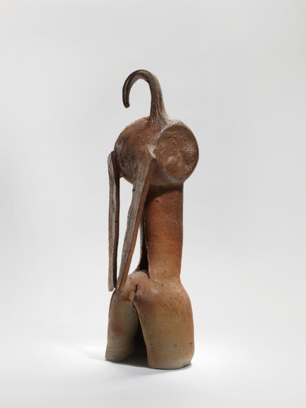 photograph of an anthropomorphic vase in an empty room