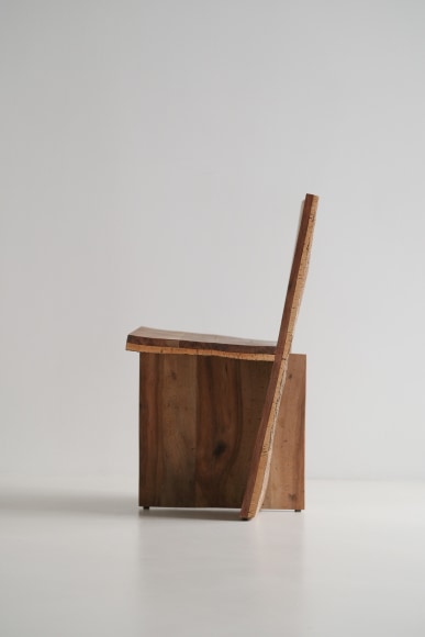 wood and cork chair with angled back shown in every angle against a grey background.