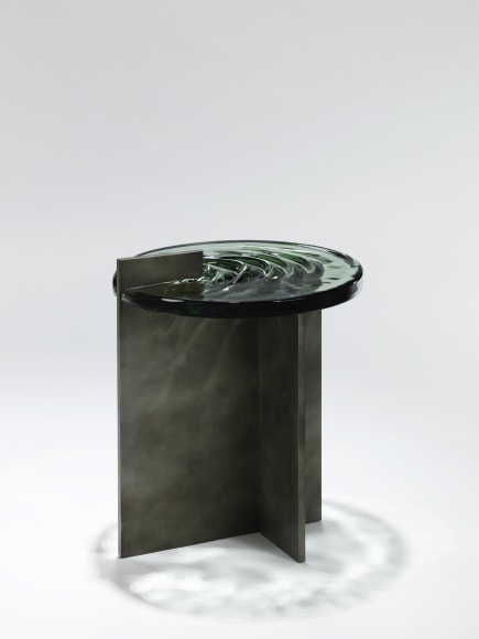 Madonna side table in aluminum and glass against a plain white background.