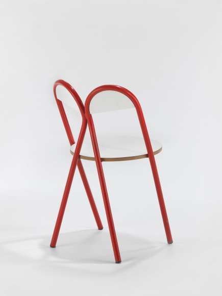 Red and white chair in front of white background