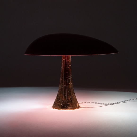 Illuminated lamp with a red raku glazed shade and gold raku glazed base