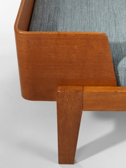 wood daybed in an empty room