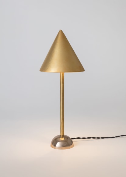 minimal gold lamp in an empty room