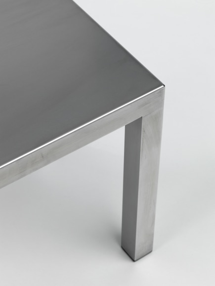 Stainless steel end tables in frond of white background