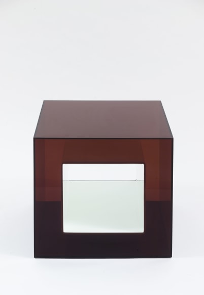 photograph of plexiglass cube in a blank room