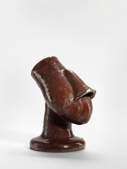 photograph of a anthropomorphic bowl in an empty room