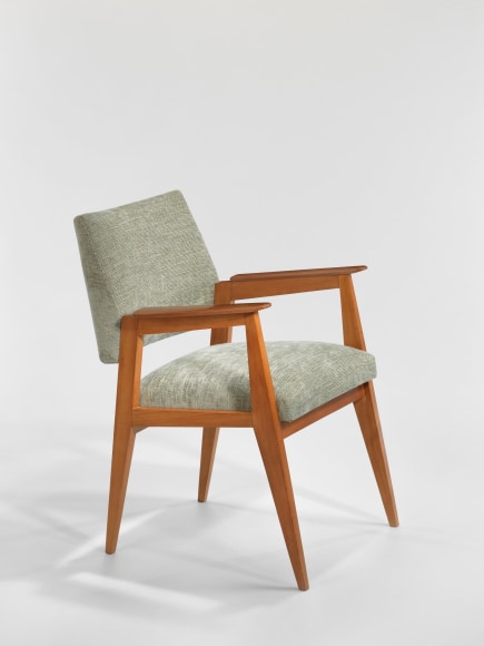 Wooden armchair with upholstered seat and back rest in front of white background