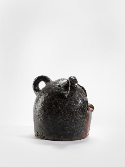 photograph of a zoomorphic frog bowl in an empty room