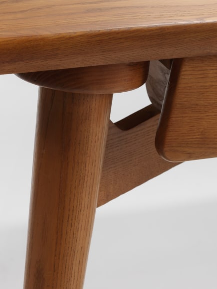photograph of a wood desk in a blank room