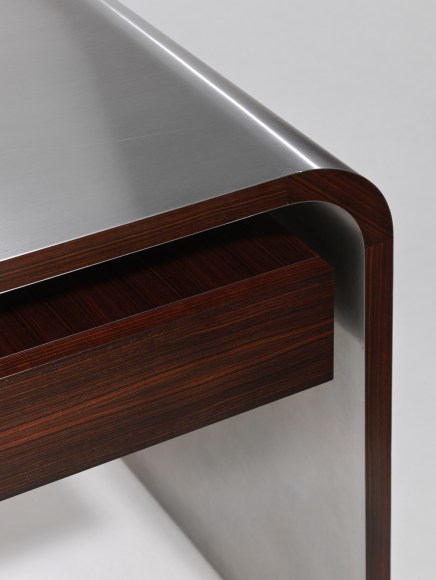 Detail view of wooden drawer and steel desktop