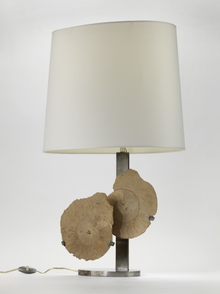 photograph of a lamp in a white room with two overlapping circles in the middle of its base