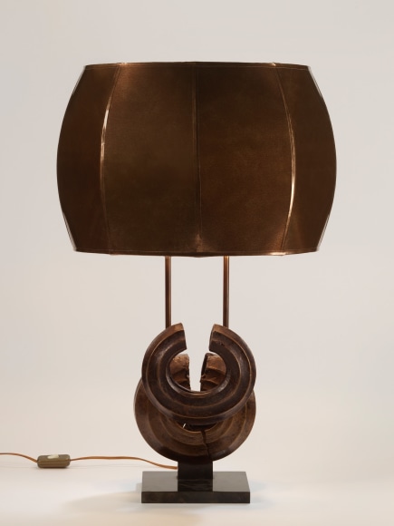photograph of a brown lamp in a white room with two overlapping circles at its base