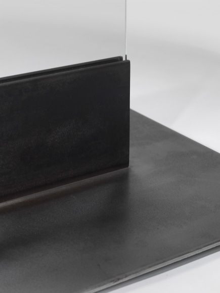 photos of a glass panel with a steel base