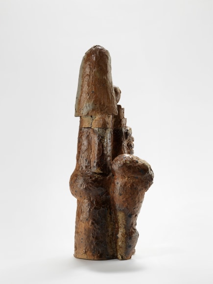 photograph of a brown sculpture in an empty room
