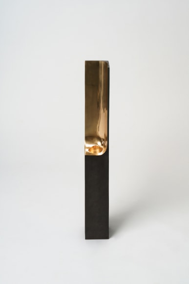 Bronze candlestick with gold detailing and black exterior.