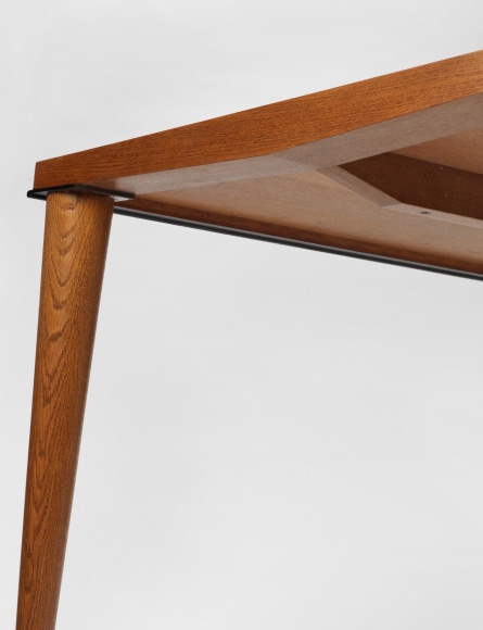 photograph of wood dining table in a blank room
