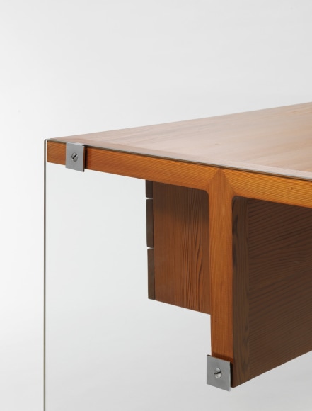 photograph of wooden desk by Motte in a blank room