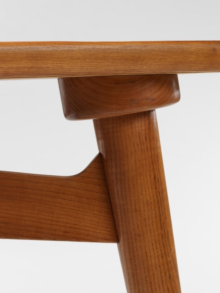 photograph of a wood desk in a blank room