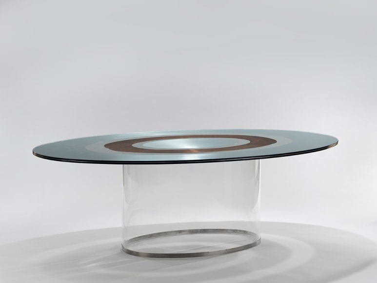 picture of a table with glass base in a gray room