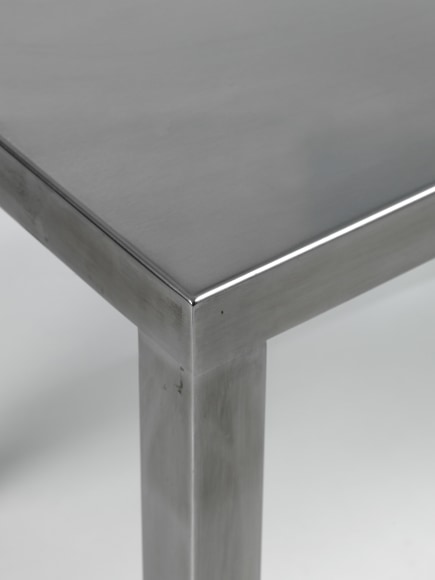 Stainless steel end tables in frond of white background