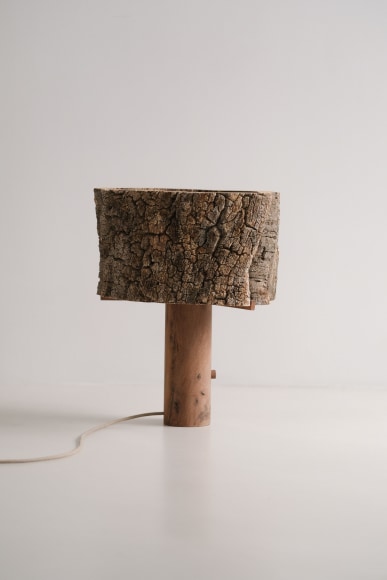two lamps made of cork and oak against grey background.
