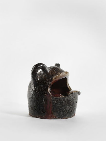 photograph of a zoomorphic frog bowl in an empty room