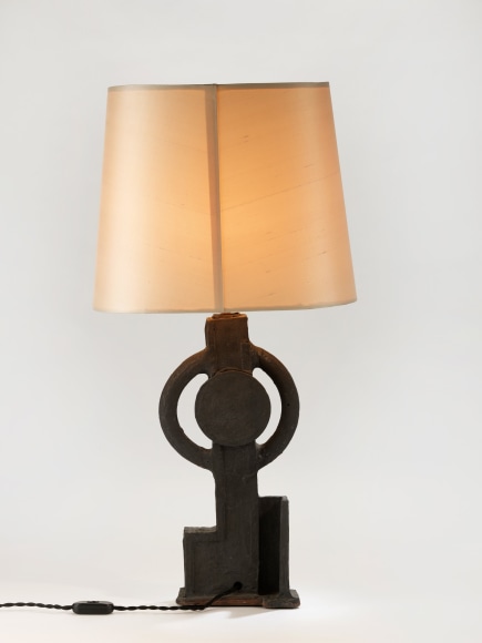 photograph of a geometric lamp in an empty room