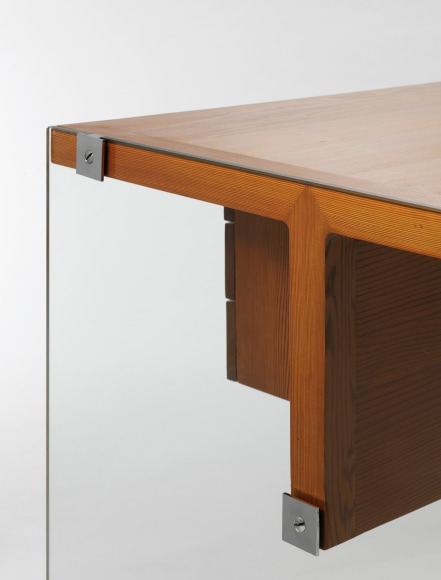 photograph of wooden desk by Motte in a blank room