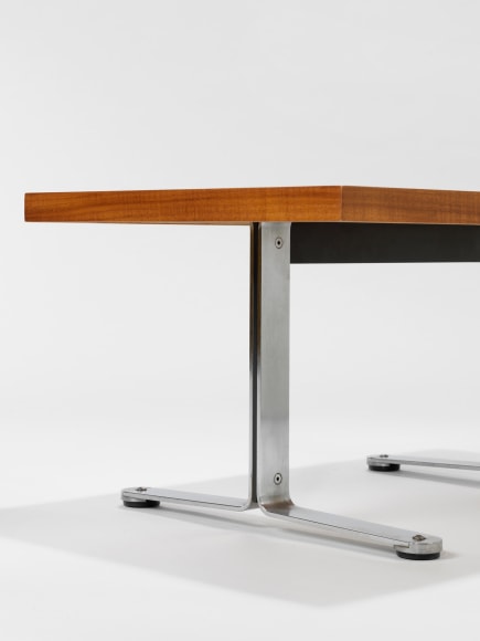photograph in blank room with table by Tallon made with teak wood top and steel and metal legs