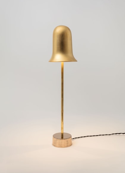 minimal gold lamp in an empty room