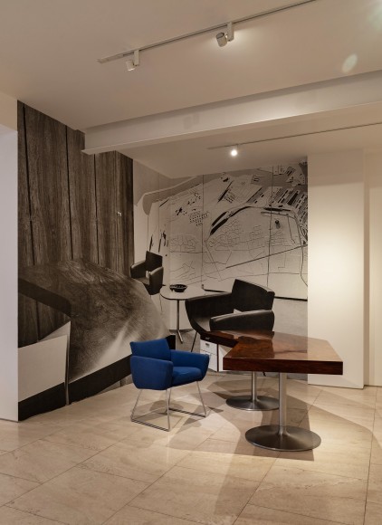 Installation view of Joseph-André Motte, Desk, 1965, with archival image wall vinyl behind. Photo by Ori Harpaz